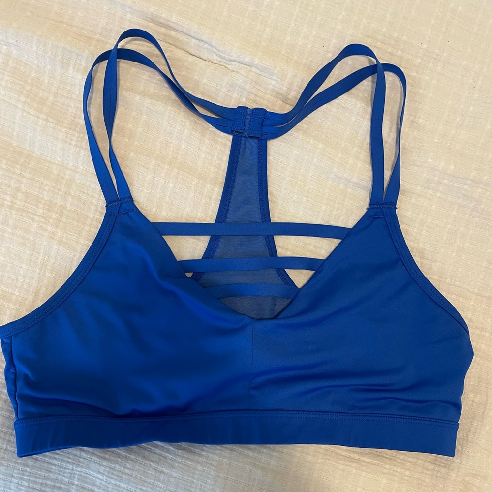 Royal blue Marika sports bra with mesh detail and fun straps! Size medium